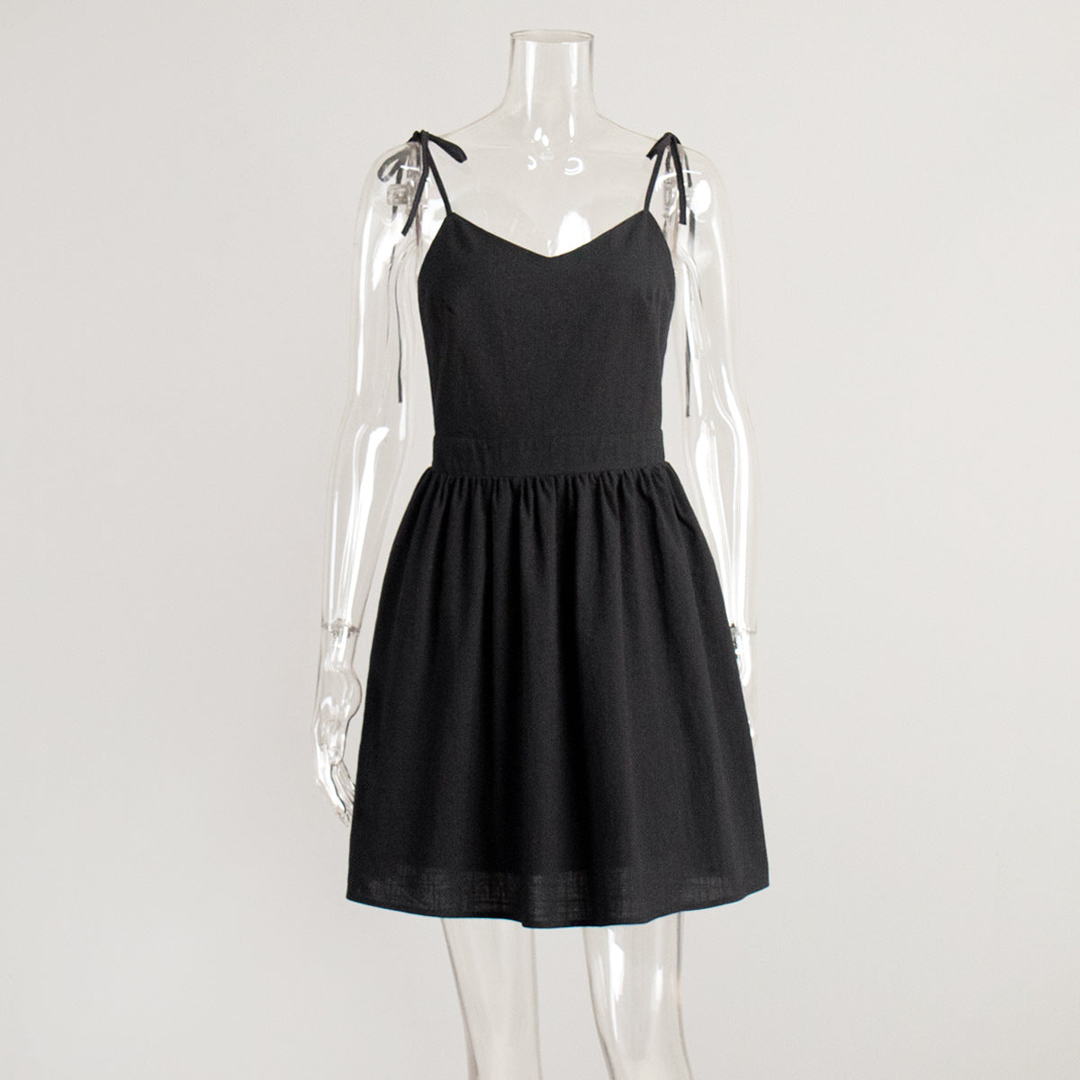 Tie-Shoulder Open-Back Cotton Mini Dress in Black — front view on mannequin