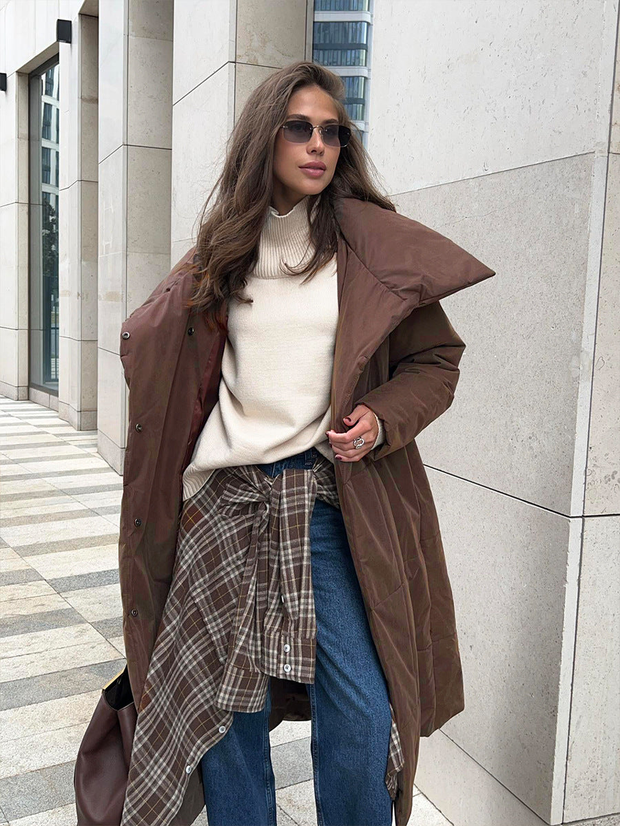 Long Belted Puffer Coat with Oversized Collar in Chocolate Brown — worn open over a sweater