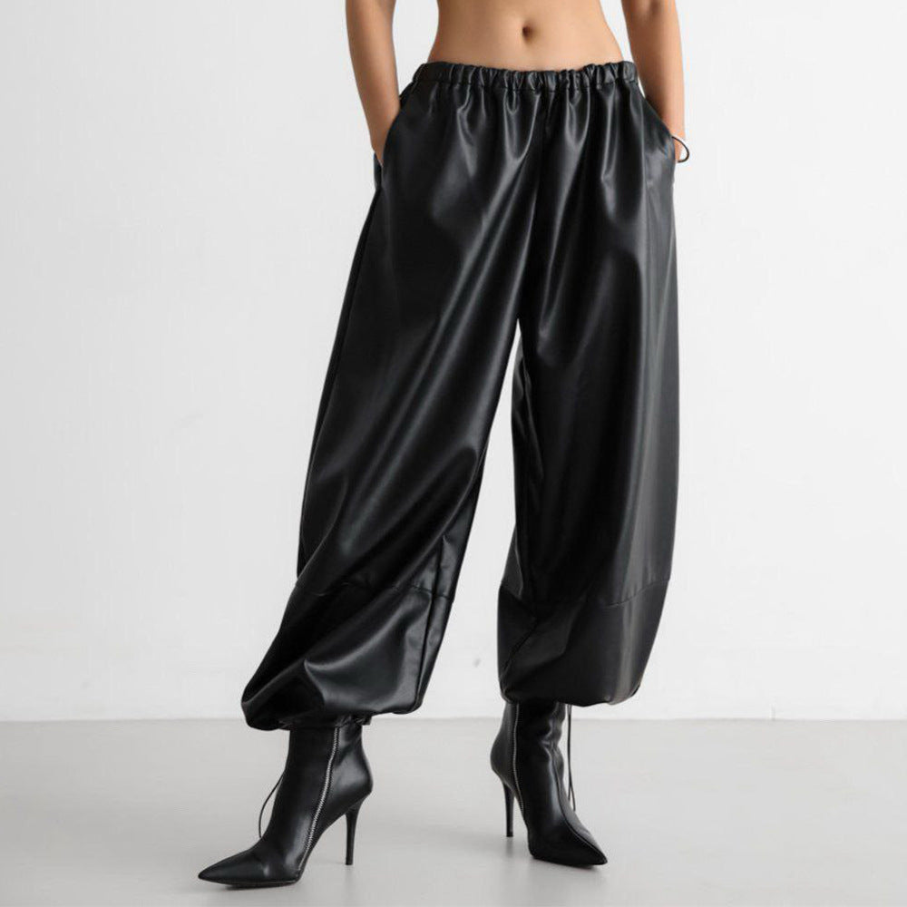 Faux Leather Balloon Pants with Drawstring Ankles in Black — front view on model with pointed boots