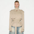 Cropped Double-Breasted Trench Jacket with Belt and Epaulettes in Khaki — front view on model, buttoned and belted with the collar up