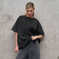 Oversized Washed Cotton Crewneck Tee in Washed Black — front view on model