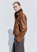 Cropped Double-Breasted Faux Leather Jacket in Cognac — front view on model