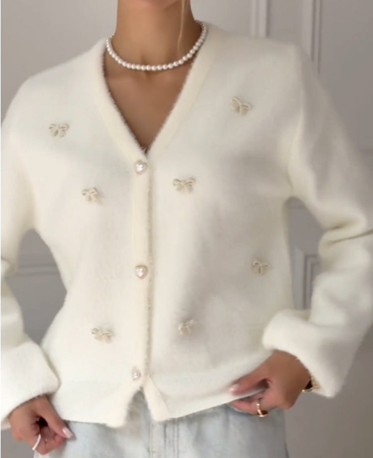 Soft Bow-Embellished V-Neck Cardigan in Ivory — close front view on model