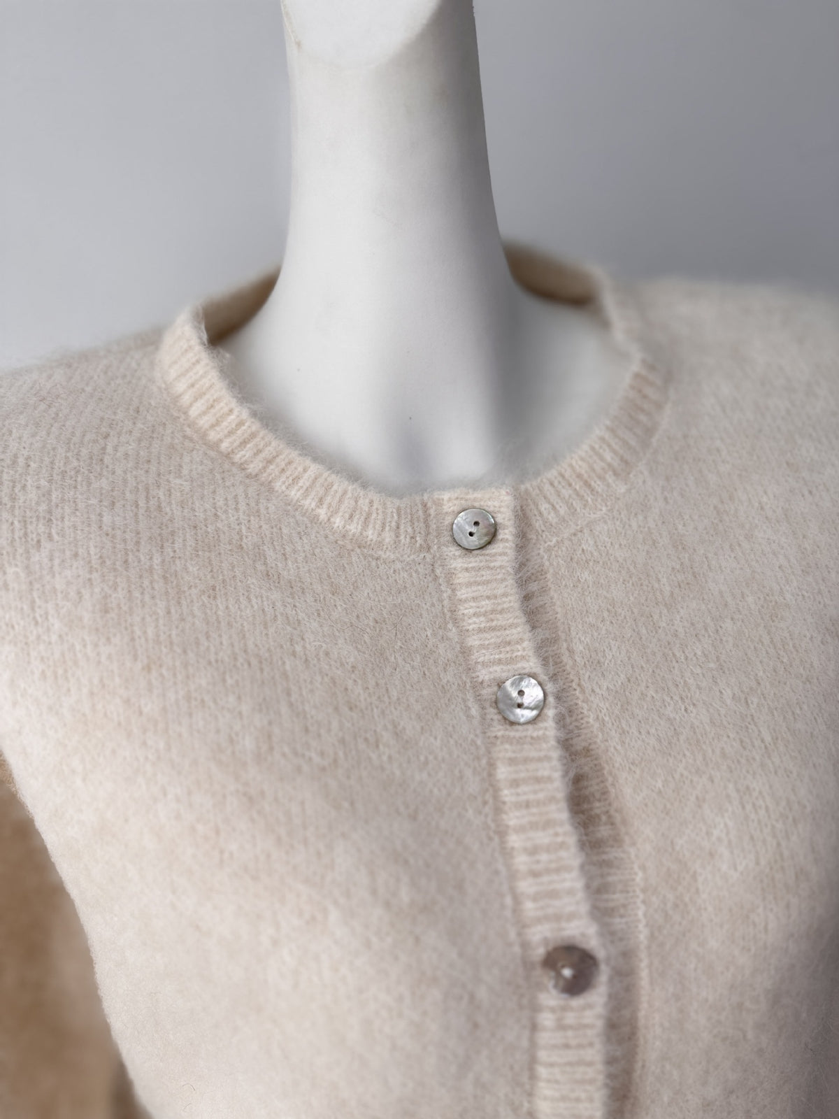 Fuzzy Wool-Blend Crew-Neck Button Cardigan in Ivory — close-up of the neckline and buttons