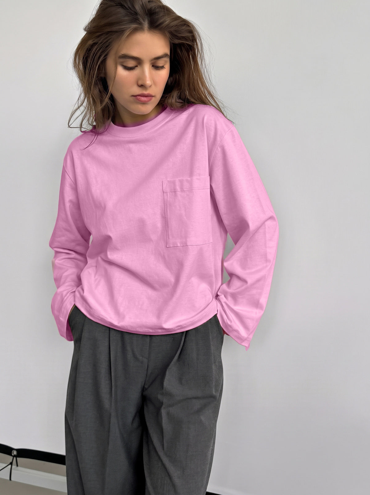 Relaxed Cotton Long-Sleeve Pocket Tee in Pink — front view on model with gray trousers