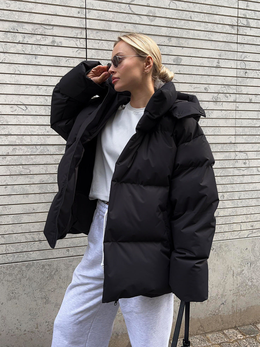 Matte Oversized Hooded Puffer Jacket in Black — zipped up on model