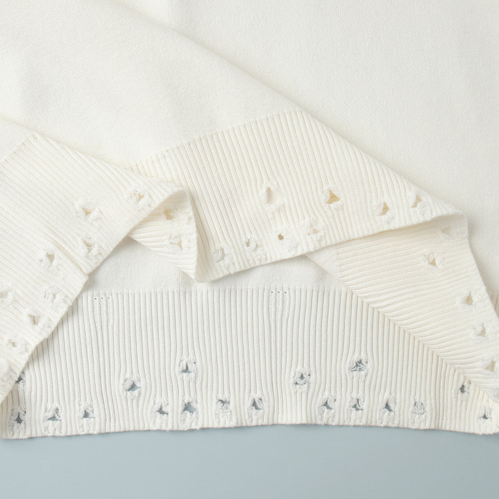 Distressed-Hem Oversized Knit Sweater & Jogger Set in Cream — close-up of the distressed cuff