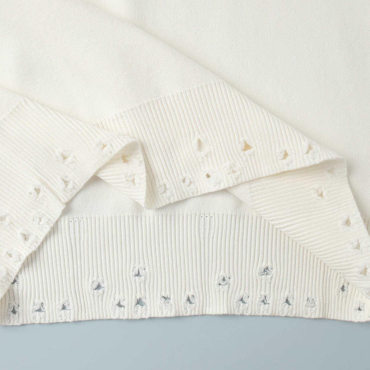 Distressed-Hem Oversized Knit Sweater & Jogger Set in Cream — close-up of the distressed cuff