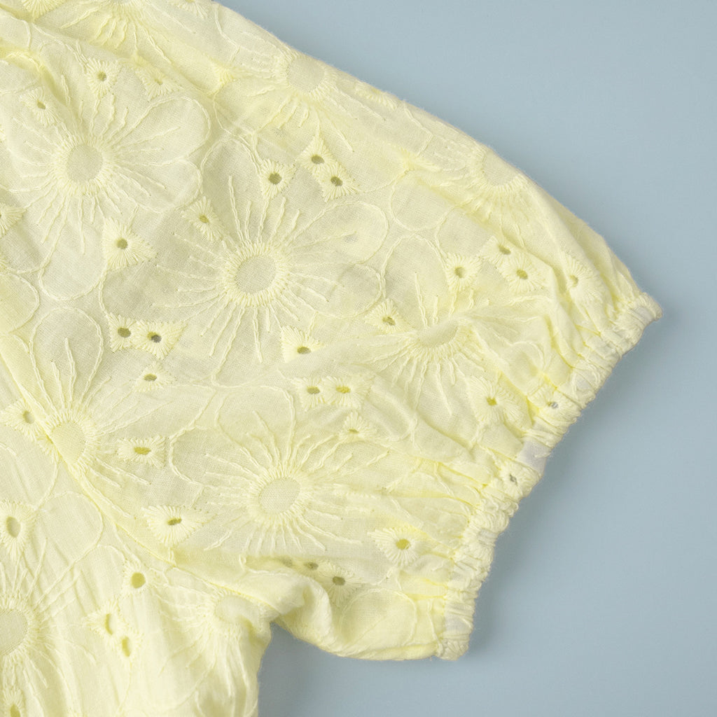 Yellow Eyelet Puff-Sleeve Mini Dress in Pale Yellow — close-up of the puff sleeve