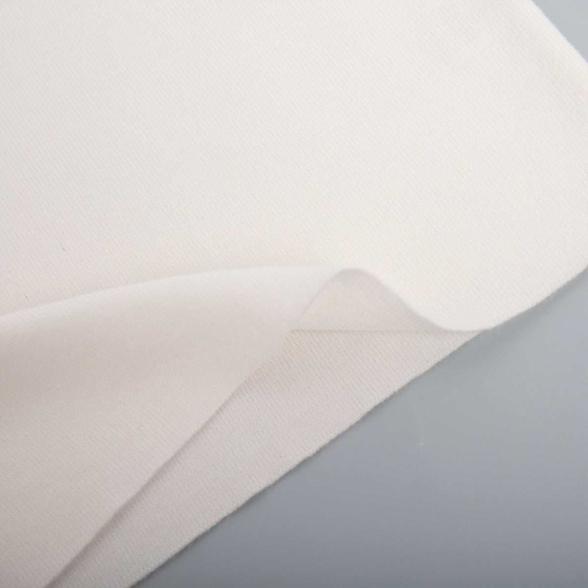 Off-Shoulder Fold-Over Knit Sweater in Ivory — close-up of the fold-over band