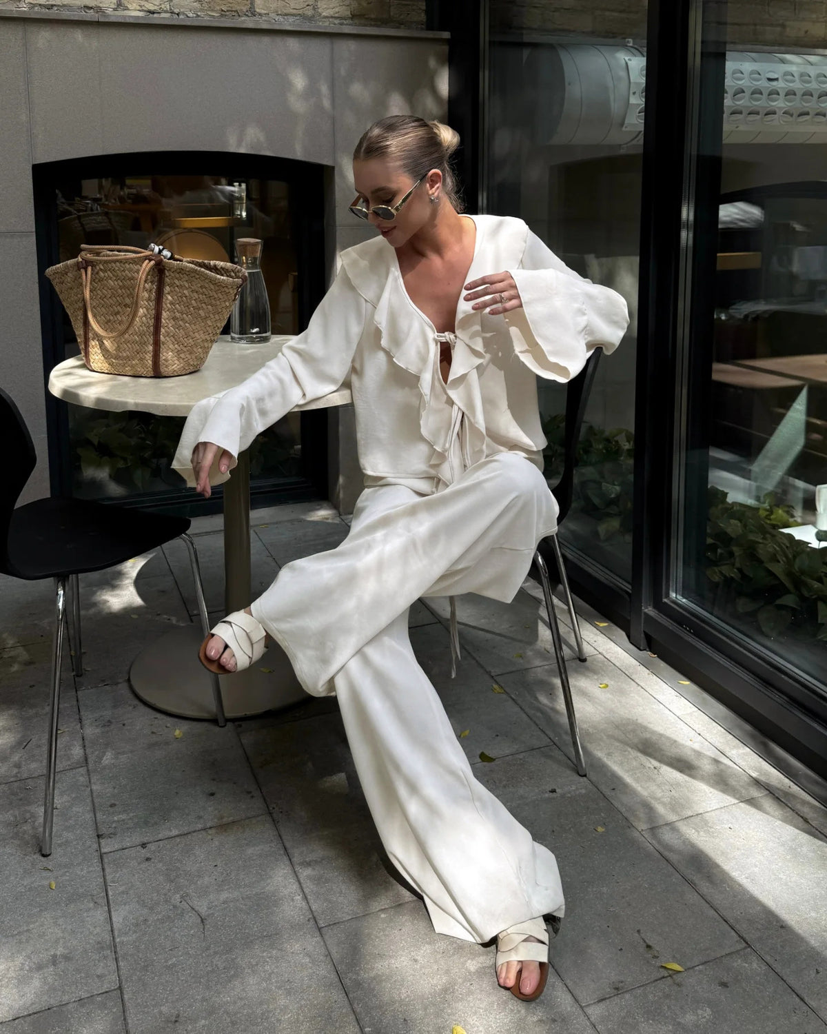 Ruffle Tie-Front Blouse and Wide-Leg Pants Set in Cream — seated view on model