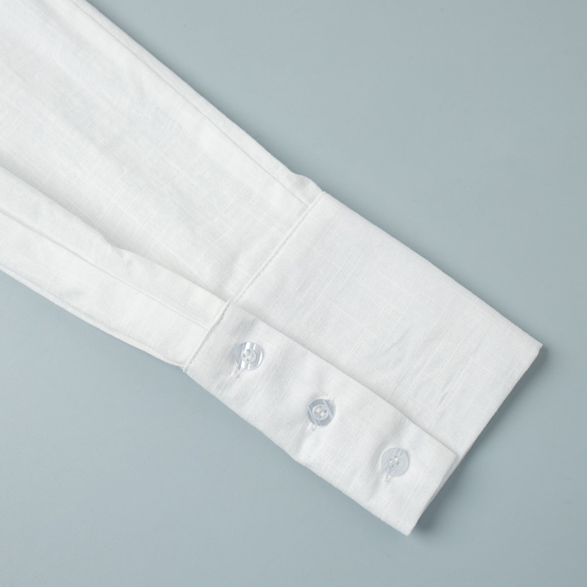 Tie-Front Cotton Mini Shirt Dress in White — close-up of the sleeve cuff
