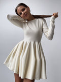 Fitted Knit Skater Mini Dress with Long Sleeves in Ivory — front view on model