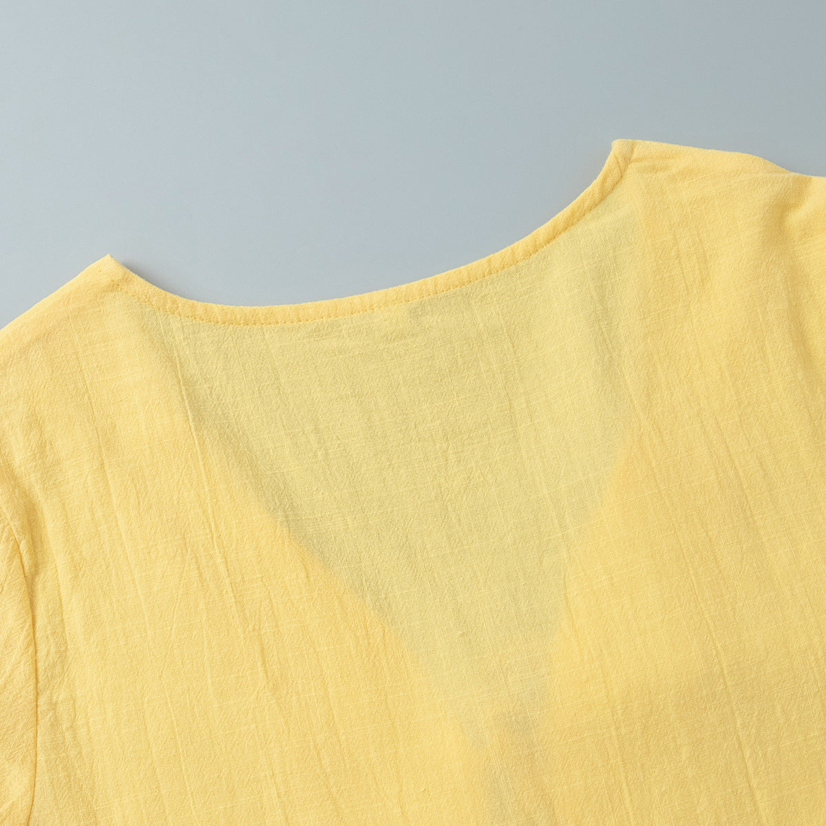 Tie-Front Puff-Sleeve Top & Maxi Skirt Set in Butter Yellow — close-up of the puff sleeve cuff