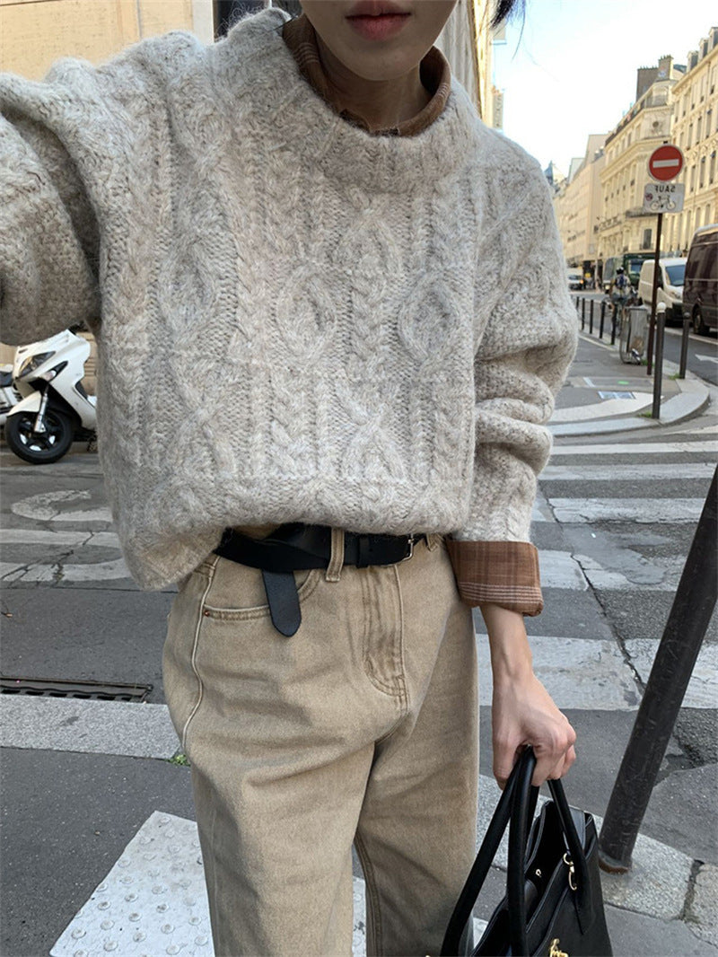 Chunky Cable-Knit Crew-Neck Sweater in Ivory — on model with a belt