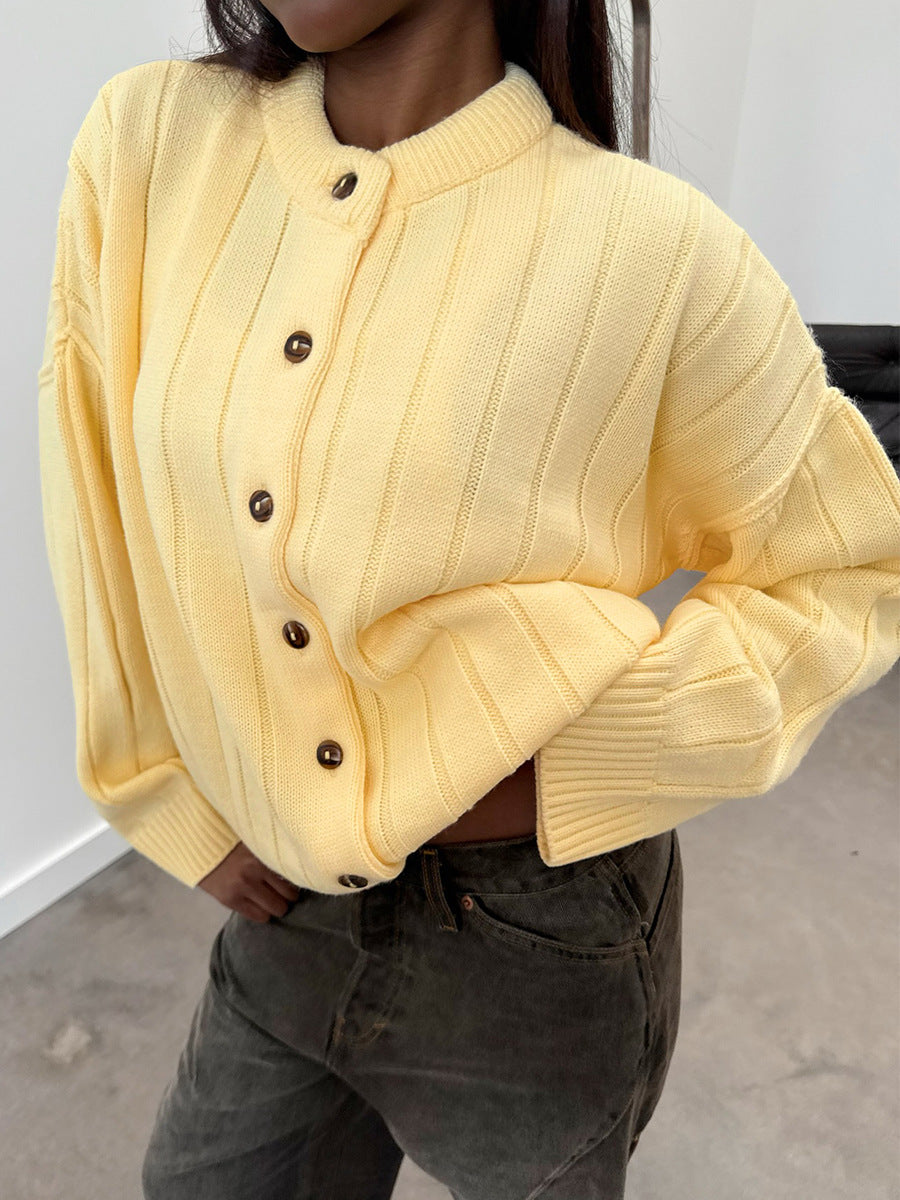Oversized Wide-Rib Crew Neck Button Cardigan in Butter Yellow — close view of the button front on model