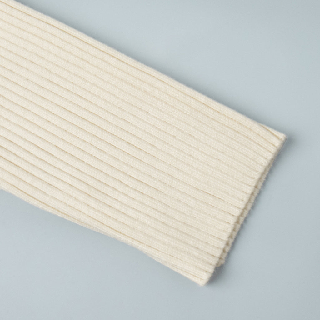 Ribbed Knit V-Neck Long Sleeve Maxi Dress in Cream — close-up of ribbed sleeve cuff