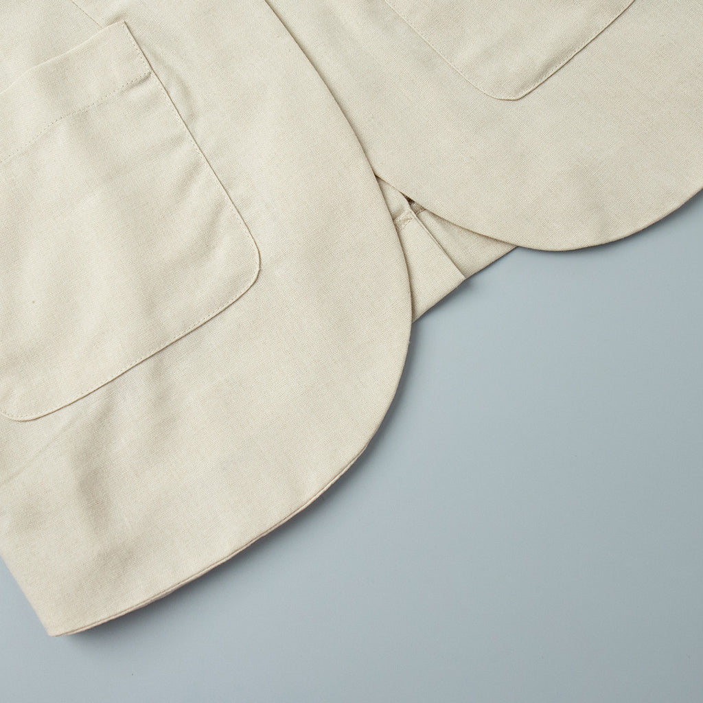 Linen-Blend Vest & Column Maxi Skirt Set in Cream — close-up of vest curved hem