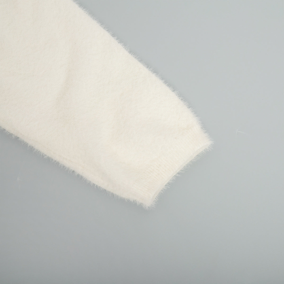 Soft Fuzzy V-Neck Sweater & Knit Maxi Skirt Set in Ivory — close-up of the cuff