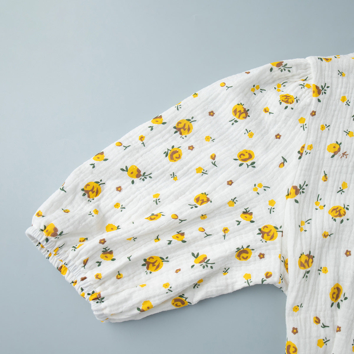Cotton Floral Puff-Sleeve Wrap Midi Dress in Yellow Floral — close-up of the puff sleeve cuff