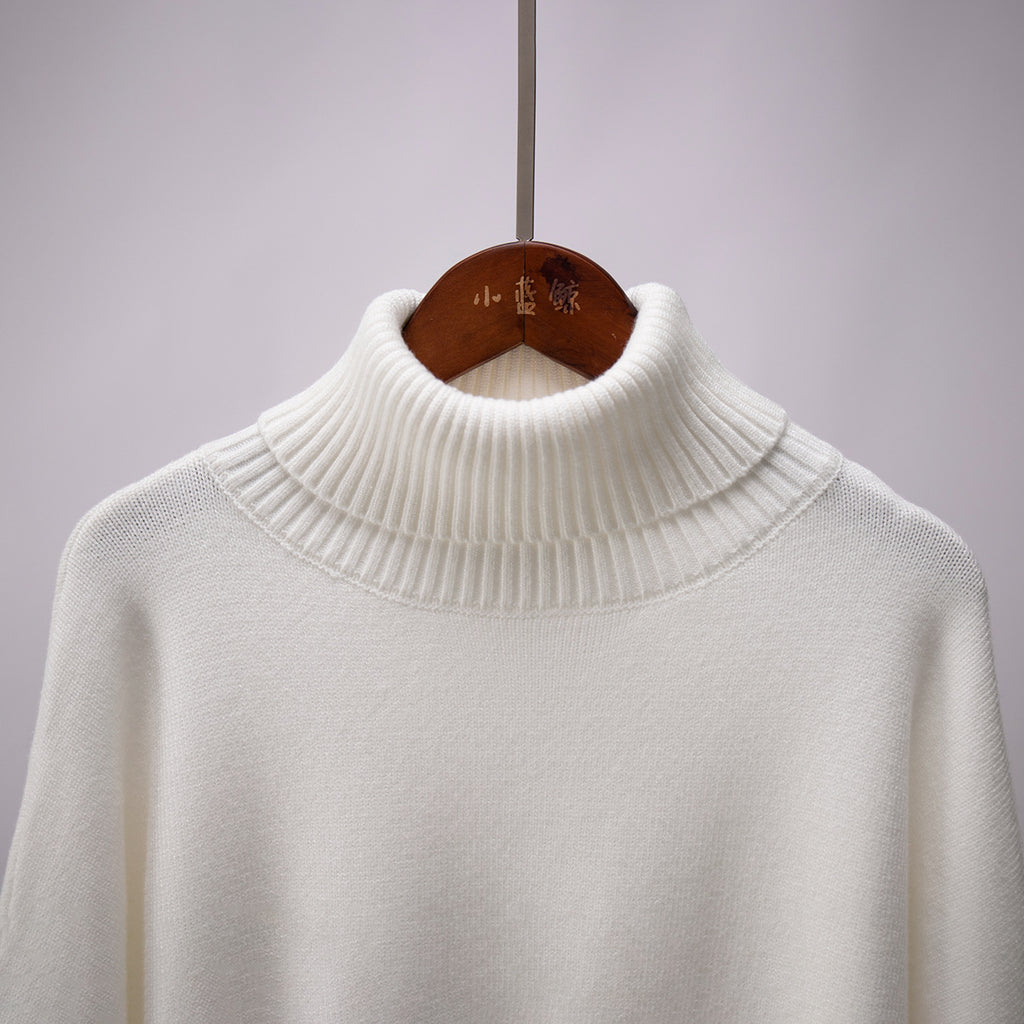 Oversized Knit Turtleneck Sweater in Ivory — close-up of ribbed turtleneck
