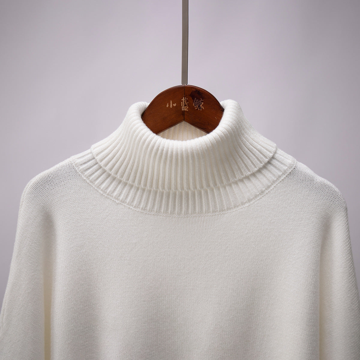 Oversized Knit Turtleneck Sweater in Ivory — close-up of ribbed turtleneck