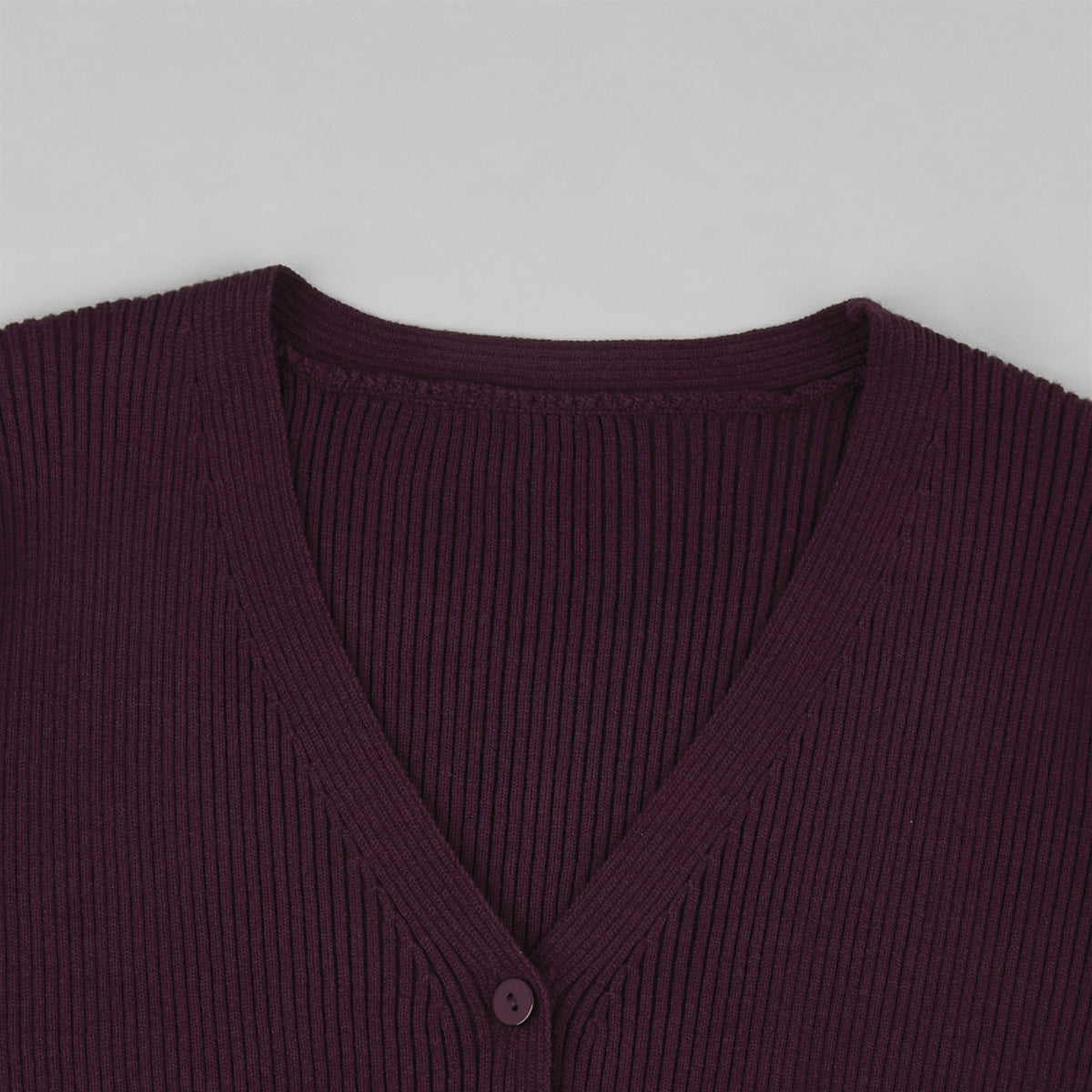 Ribbed V-Neck Button Cardigan & Fitted Knit Maxi Skirt Set in Plum — close-up of the V-neck