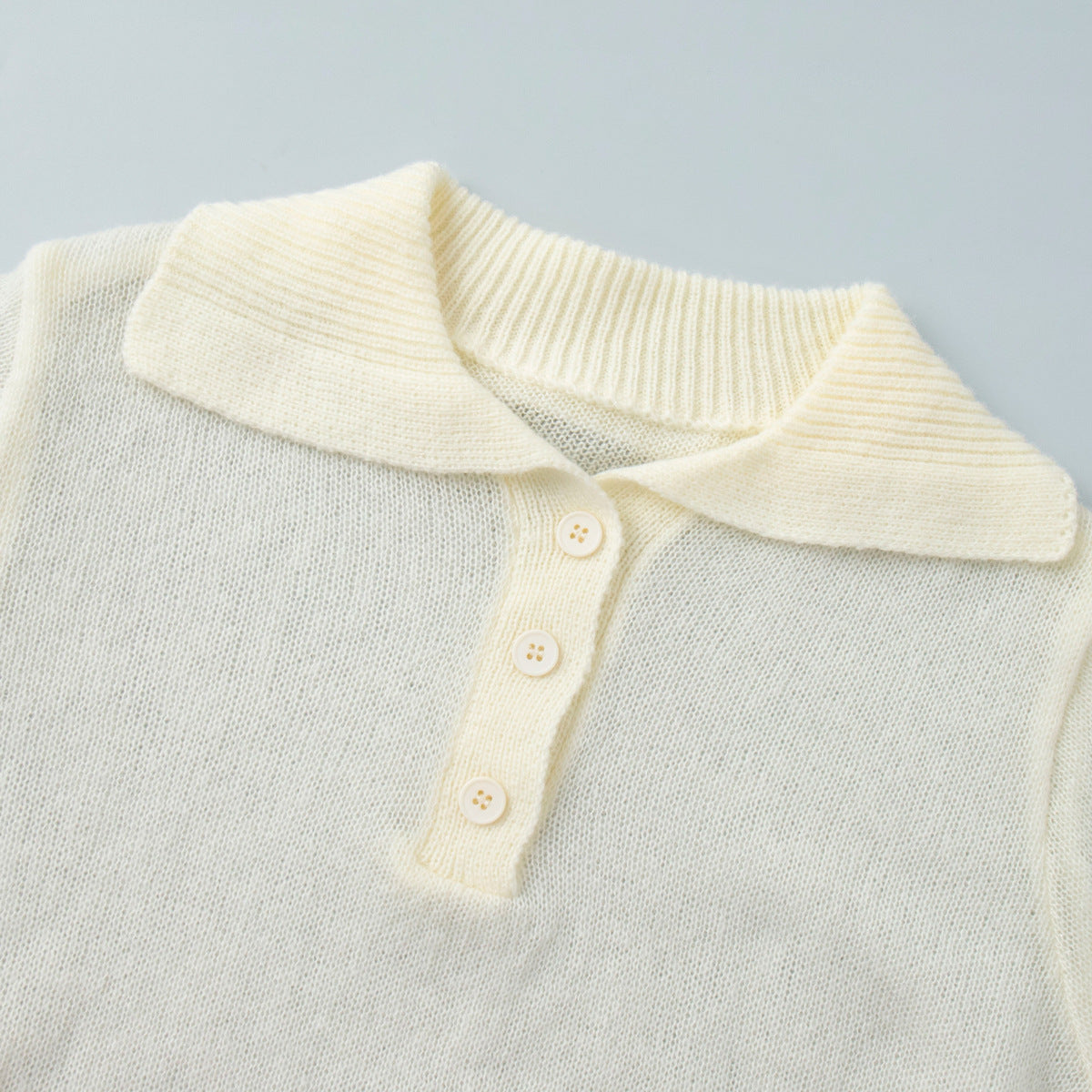 Soft Knit Short Sleeve Polo Top in Cream — close-up of the soft knit texture