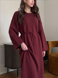 Relaxed Knit Maxi Sweater Dress with Tie Waist in Burgundy — front view on model with the tie at the waist