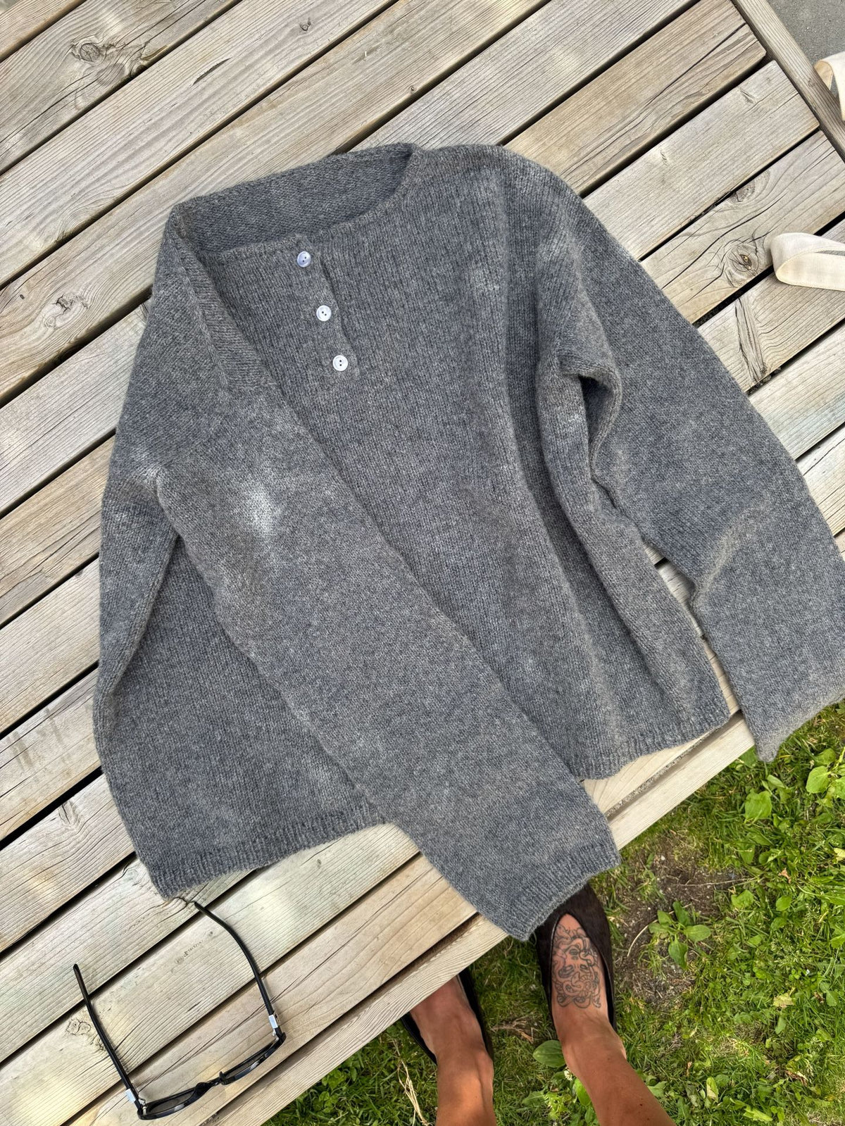 Relaxed Henley Sweater with Button Placket in Charcoal Gray — laid flat, close view of the placket