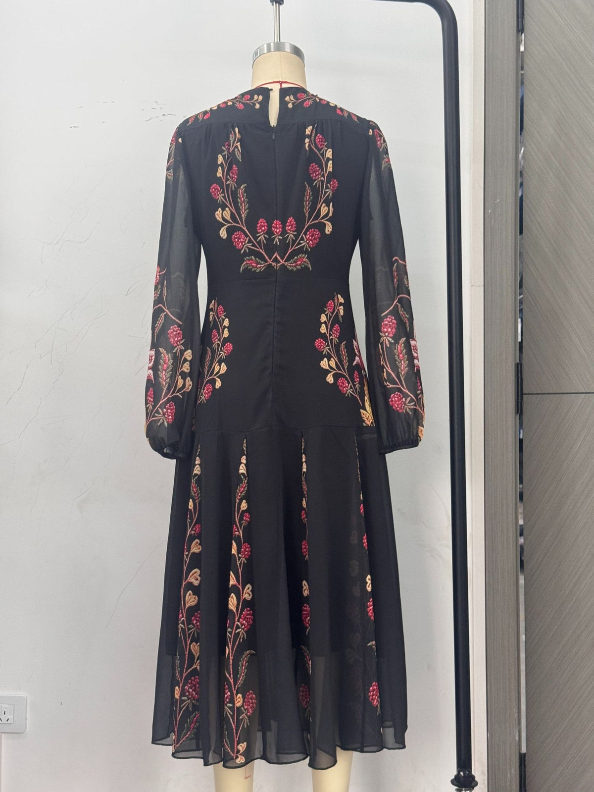 Floral Print Keyhole Midi Dress with Balloon Sleeves in Black — back view on a dress form