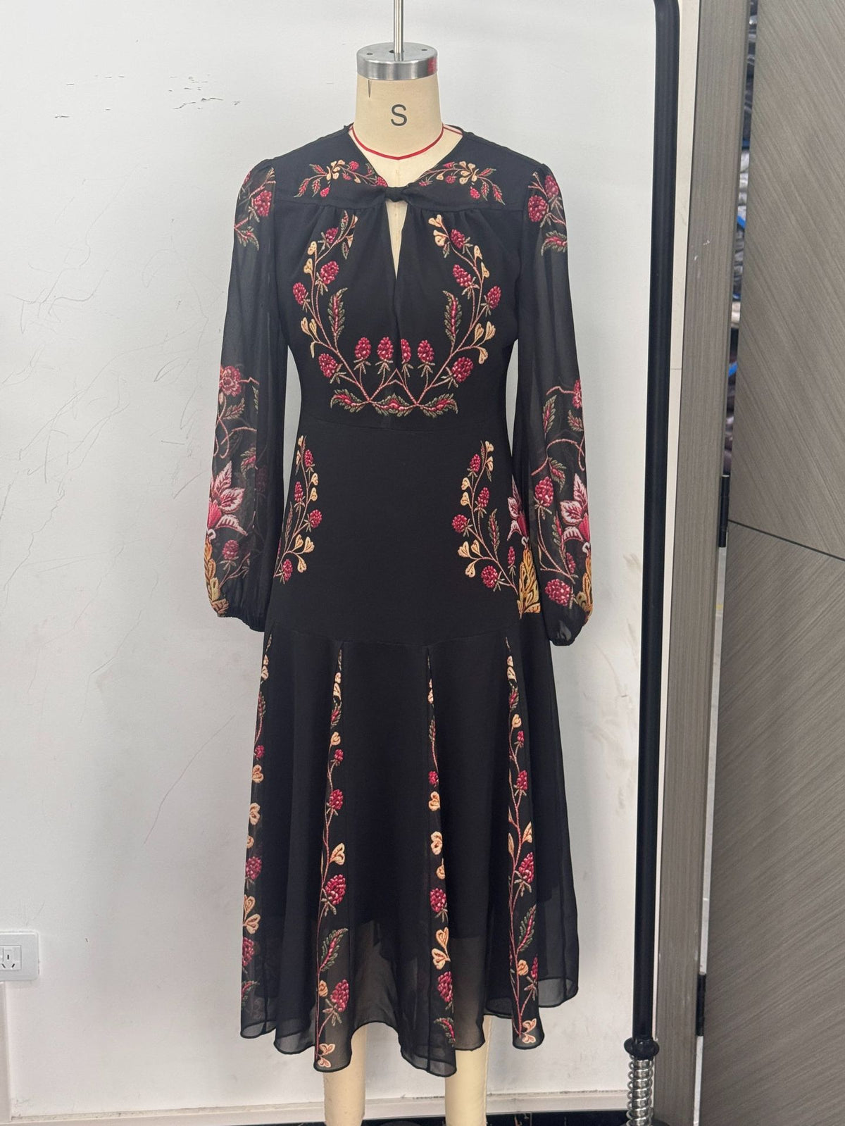 Floral Print Keyhole Midi Dress with Balloon Sleeves in Black — front view on a dress form