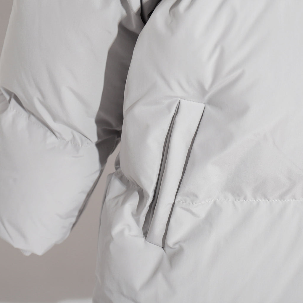 Matte Oversized Hooded Puffer Jacket in Light Gray — close-up of the side pocket