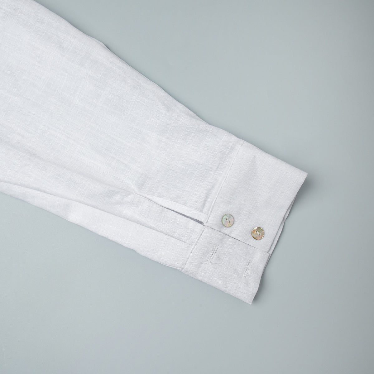 Relaxed Cotton Button-Down Shirt in White — close-up of the two-button cuff