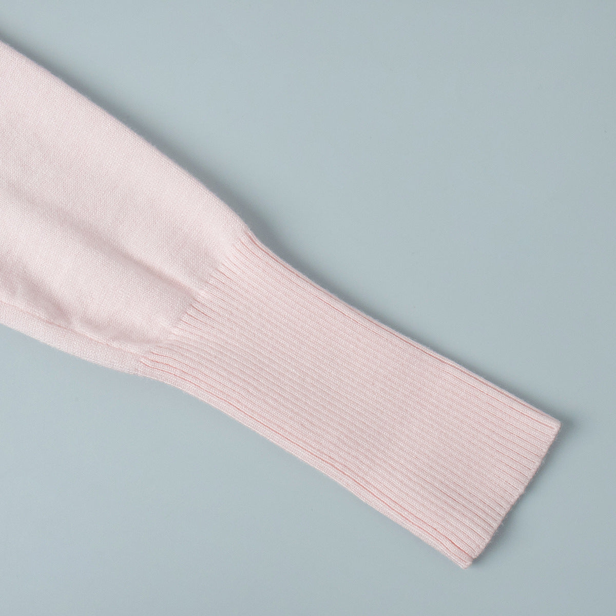 Fitted Cropped Ribbed Knit Cardigan in Blush Pink — close-up of slim sleeve and ribbed cuff