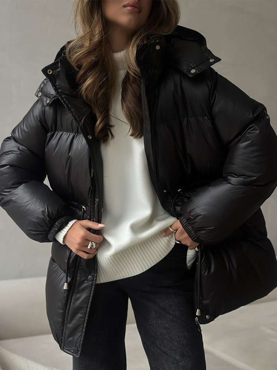 Hooded Puffer Jacket with Drawstring Waist in Black — worn open over a white sweater