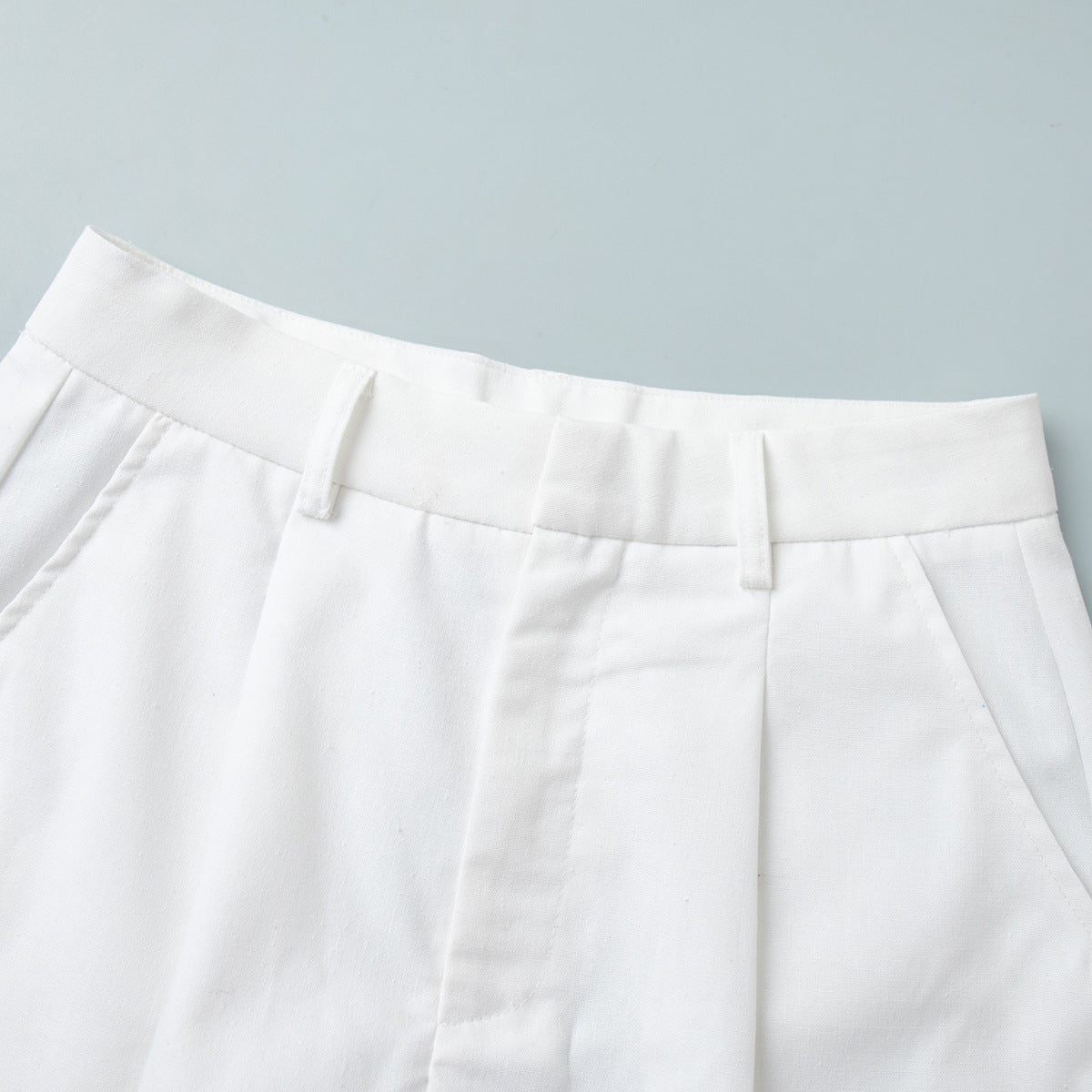 Linen-Blend Vest & Pleated Shorts Set in White — close-up of the shorts waistband