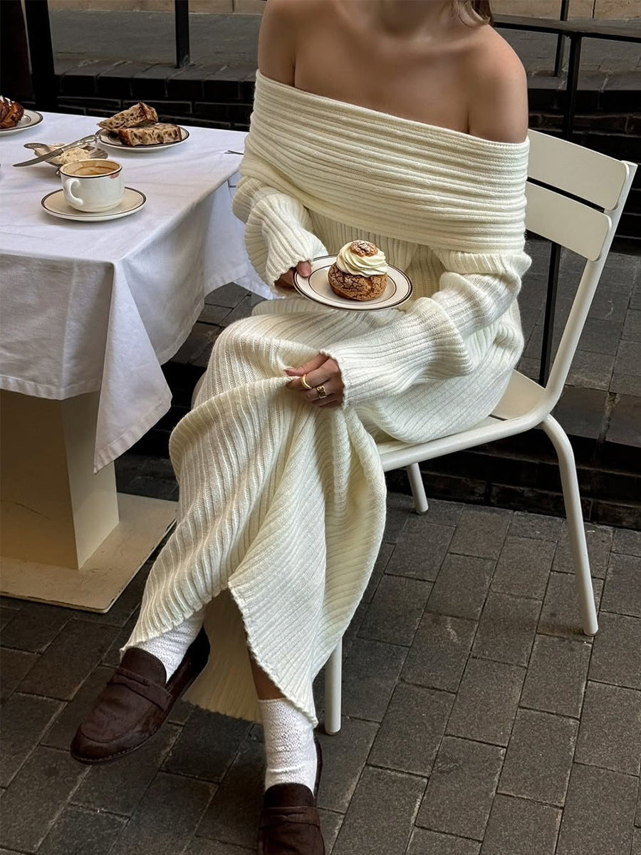 Off-Shoulder Fold-Over Collar Ribbed Knit Maxi Dress in Ivory — seated view showing the hem slit