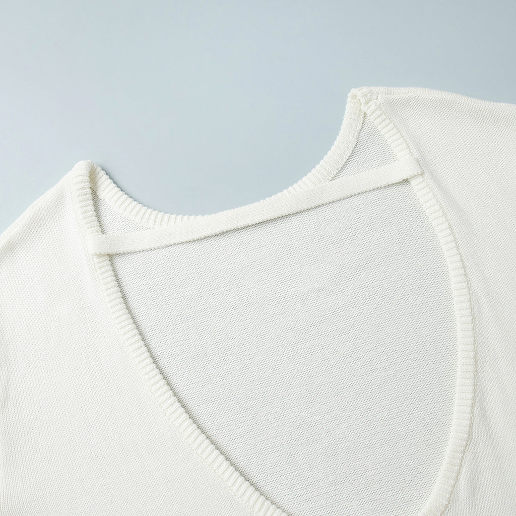Oversized Open-Back Cotton Knit Sweater in Cream — close-up of the open back and strap