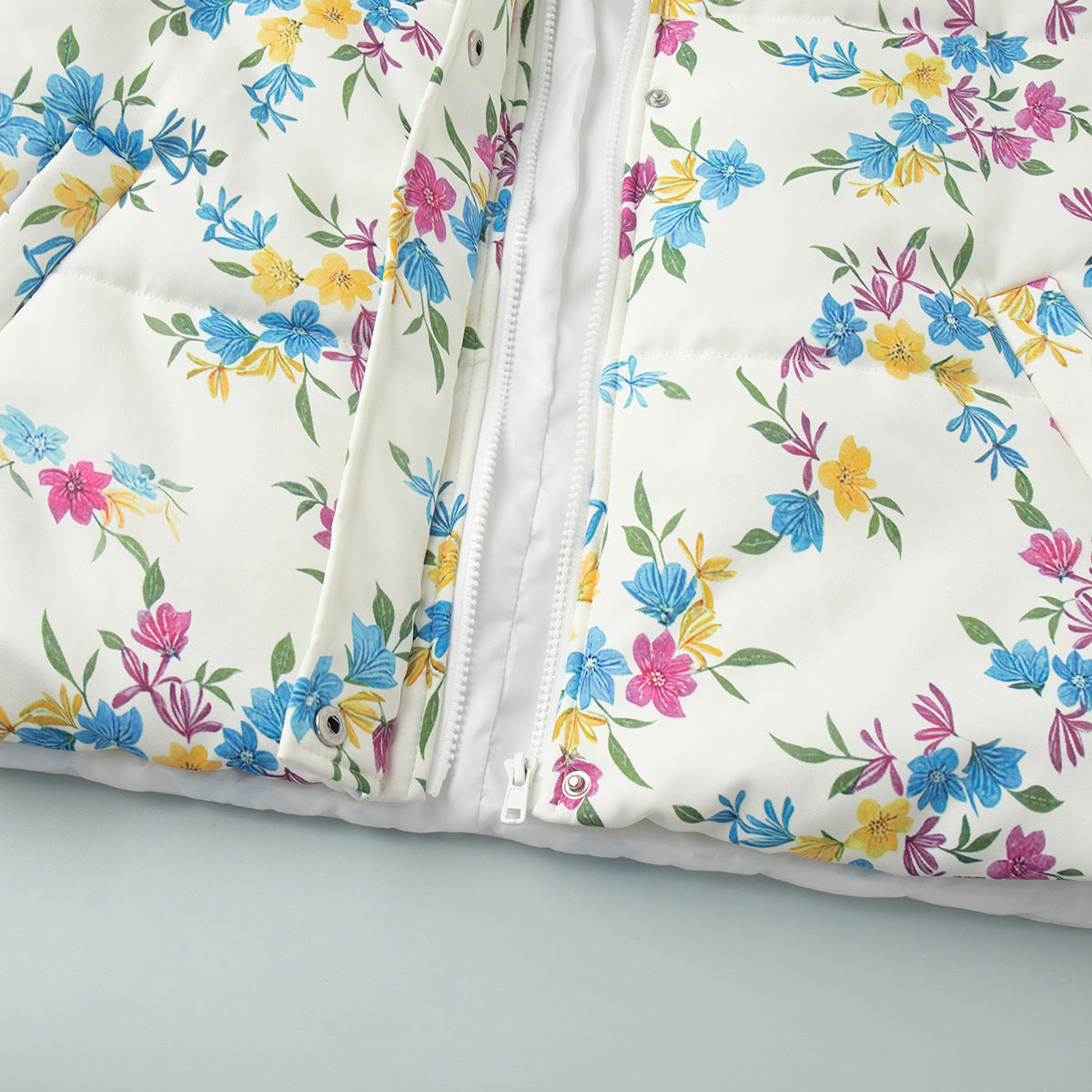 Floral Print Puffer Jacket with Stand Collar in Cream Floral — close-up of the zip front