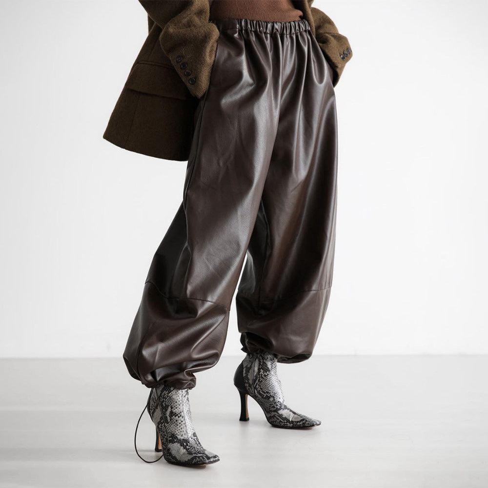 Faux Leather Balloon Pants with Drawstring Ankles in Dark Brown — on model with a brown jacket