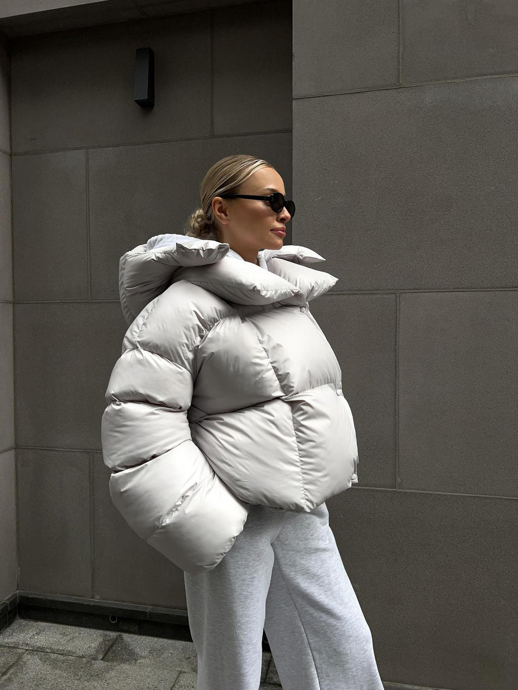 Cropped Hooded Puffer Jacket with Drawstring Hem in Light Gray — front view on model