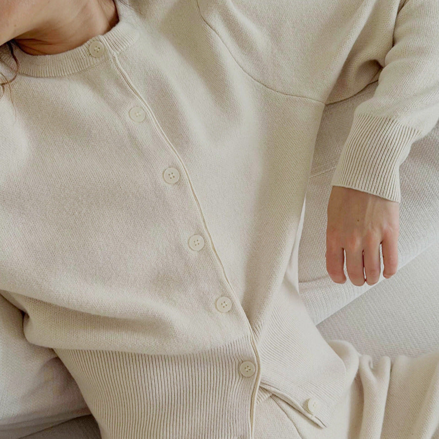 Crew Neck Button Cardigan & Straight-Leg Knit Pants Set in Oat — close-up of the buttons on model