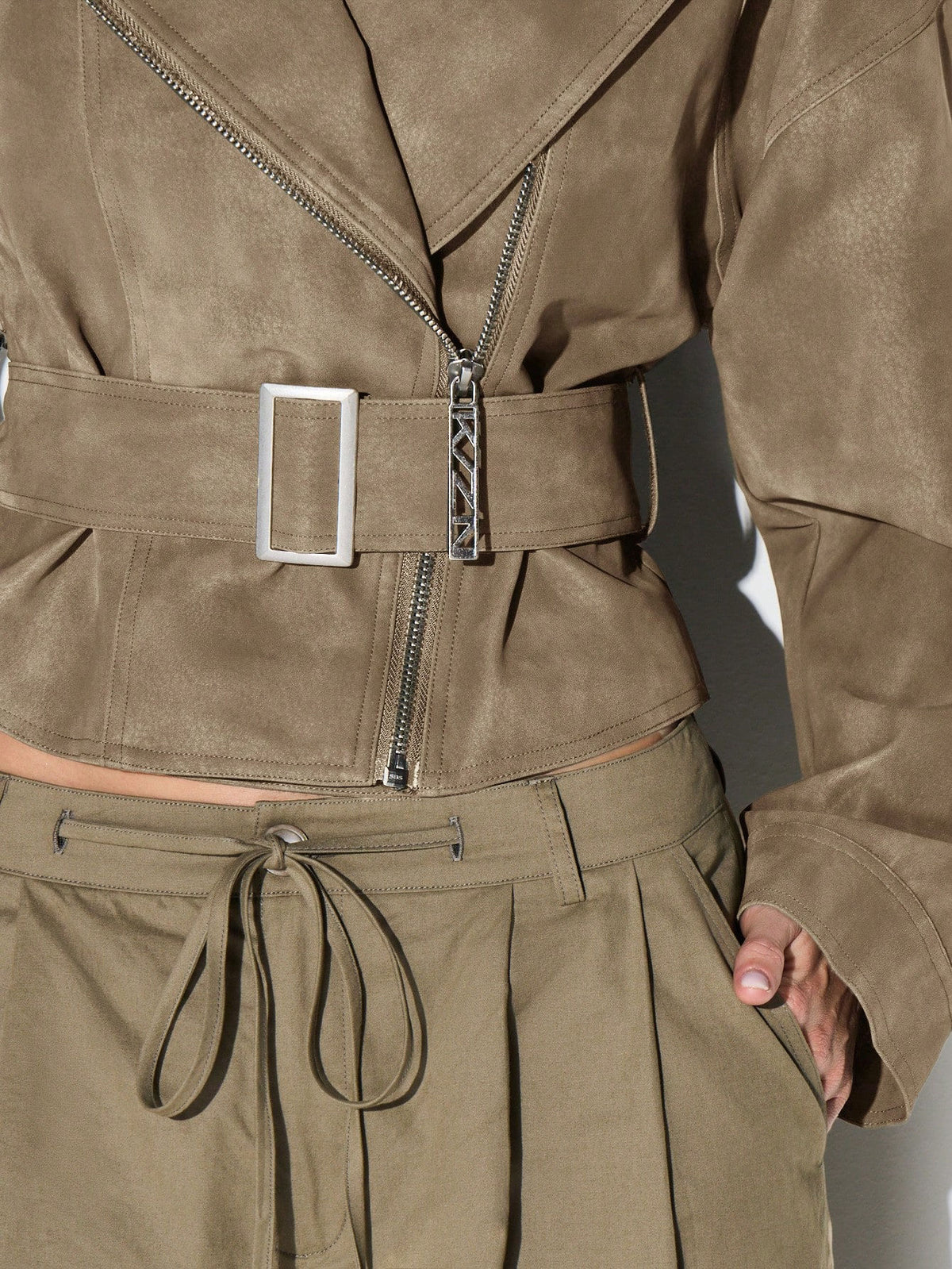 Belted Faux Suede Moto Jacket with Asymmetric Zip in Khaki — close-up of the belt buckle and asymmetric zip