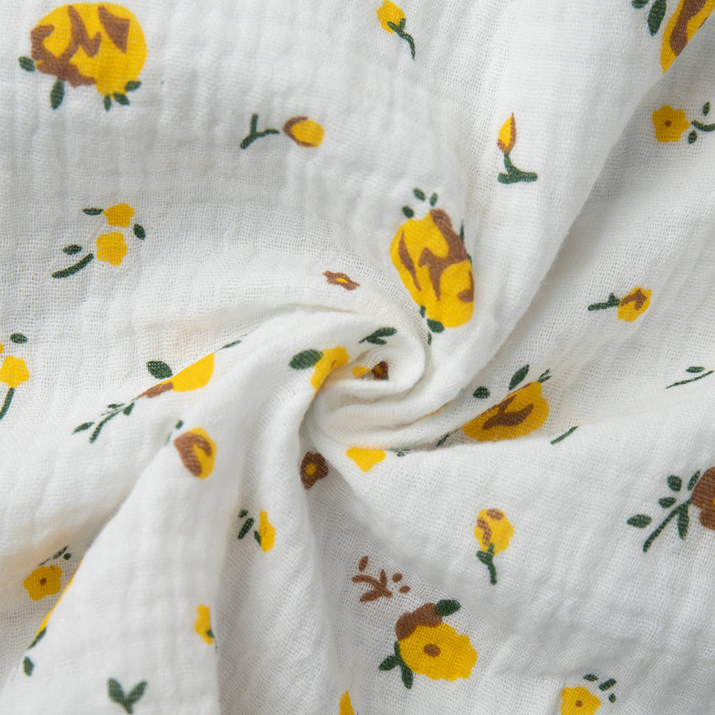 Cotton Floral Puff-Sleeve Wrap Midi Dress in Yellow Floral — close-up of the crinkled cotton and floral print