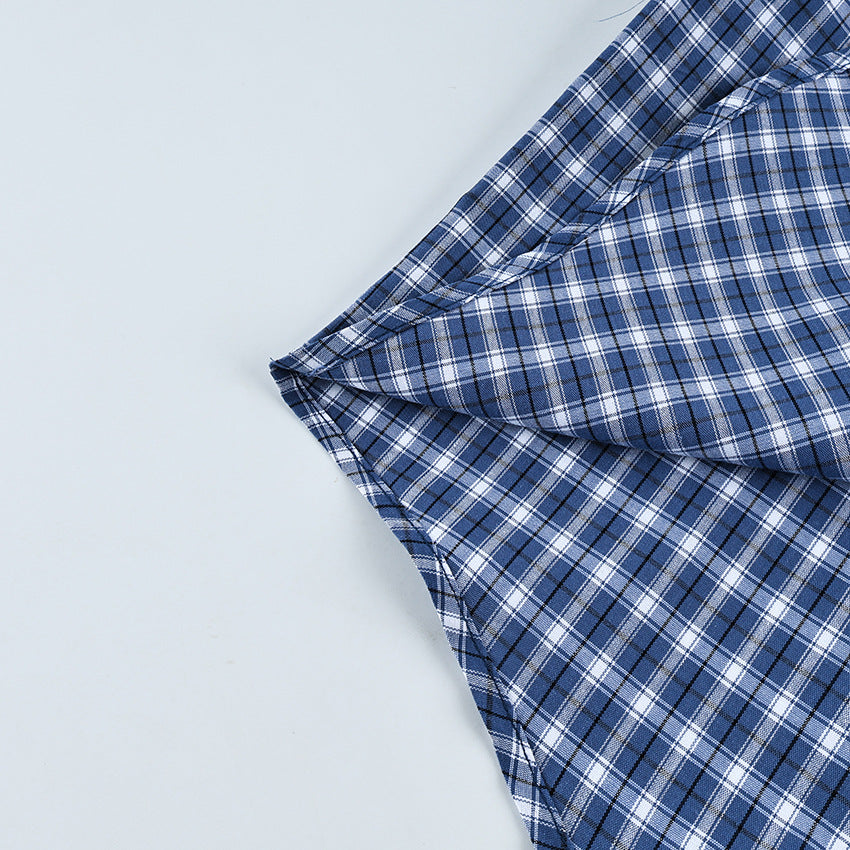 Oversized Cotton Plaid Button-Up Shirt in Navy Plaid — close-up of the curved hem