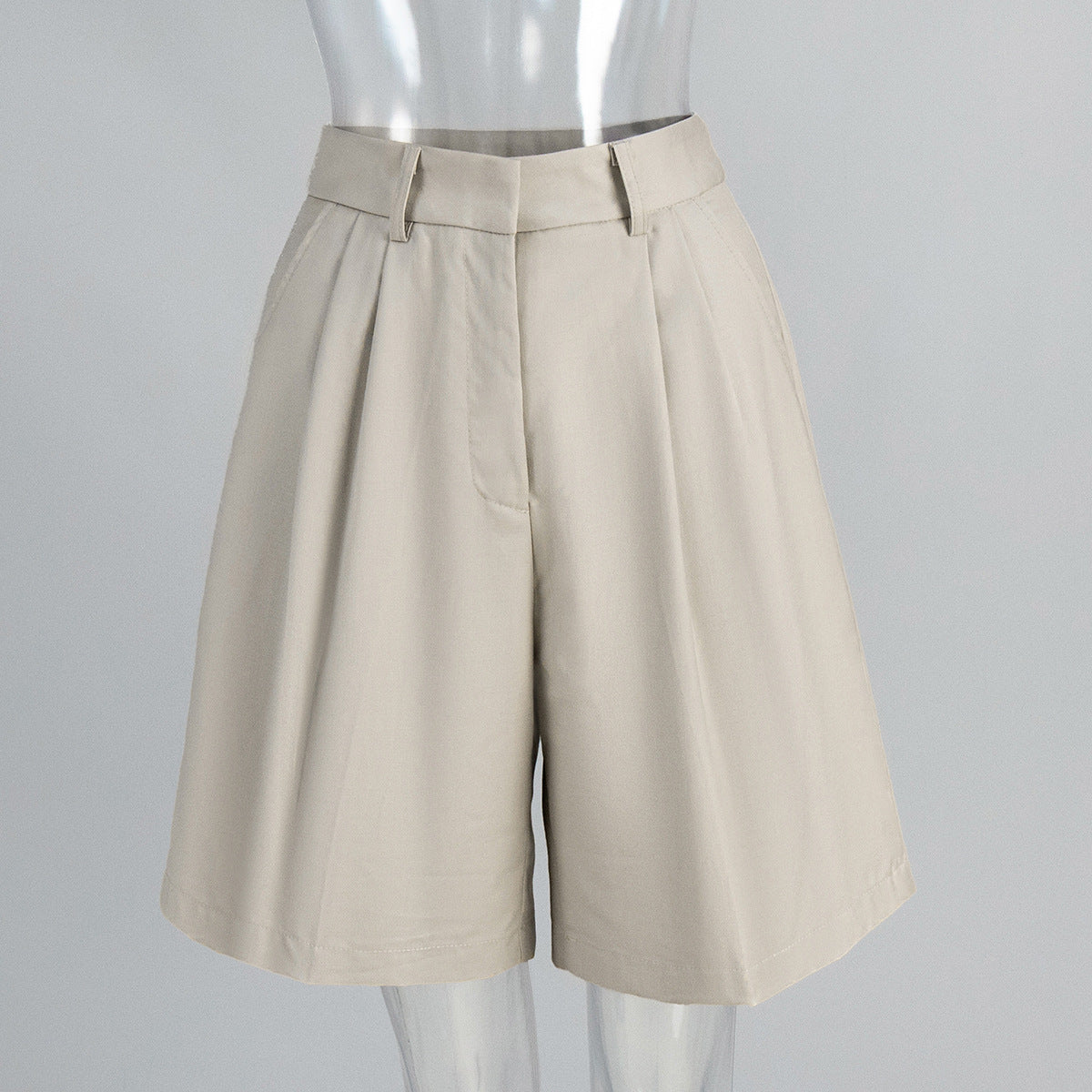 High-Waist Pleated Bermuda Shorts in Apricot — front view on mannequin