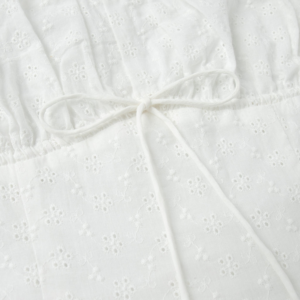 Eyelet Cotton Off-Shoulder Midi Dress in Ivory Eyelet — close-up of front lace-up tie