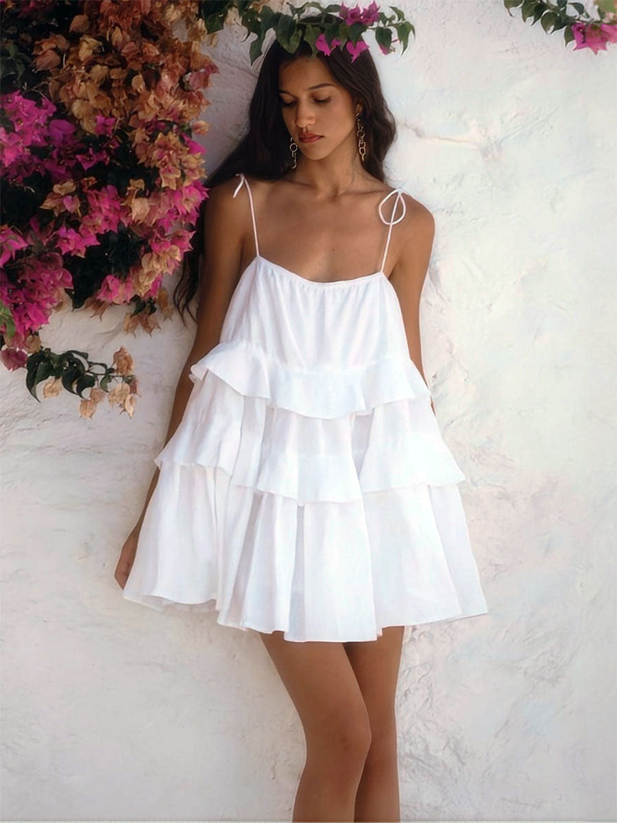 Tiered Ruffle Tie-Strap Mini Dress in White — on model outdoors