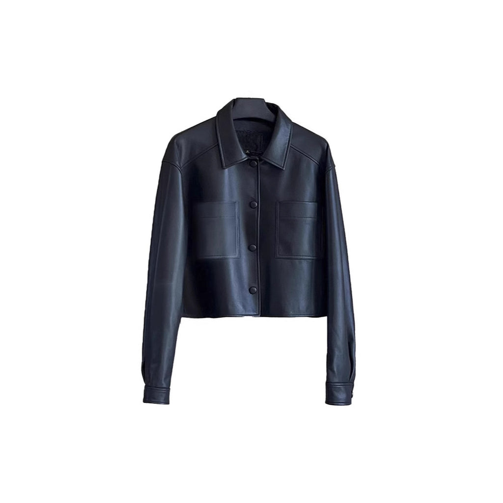 Cropped Faux Leather Shirt Jacket with Patch Pockets in Black — on a hanger, front view showing collar, snaps, and patch pockets